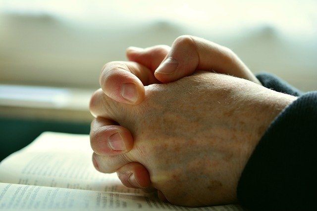 hands clasped while praying